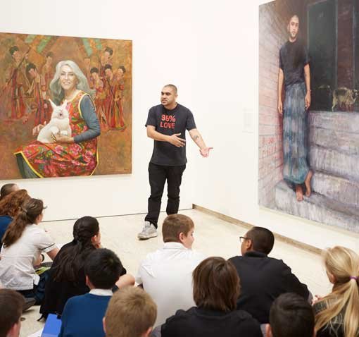 Omar Musa, poet, rapper and 2015 Archibald Prize finalist, performs for Turramurra High School students in the exhibition space at the Art Gallery of NSW